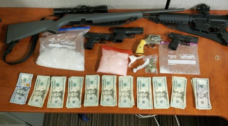 Over six ounces of methamphetamine, four handguns, two rifles and a sawed-off shotgun were found in the safe where a 22-year-old was hiding before his arrest.