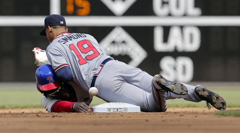 Phillies’ Odubel Herrera is safe at second base as Andrelton Simmons can’t corral a throw in the first inning Sunday at Philadelphia. (Photo by Hunter Martin/Getty Images)