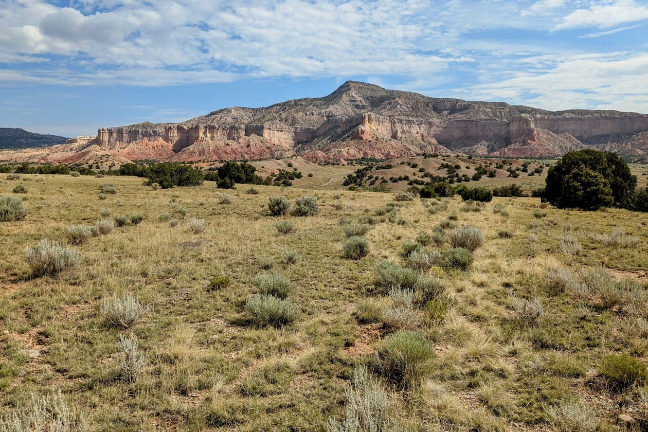 In this photo provided by Jonathan Hayden is the Ghost Ranch landscape, on July 18, 2025, near Abiguiu, N.M. A new conservation agreement announced Tuesday, Dec. 9, preserves land with breathtaking desert vistas in New Mexico near Abiquiu that inspired the work of 20th century painter Georgia O'Keeffe. (Jonathan Hayden via AP)