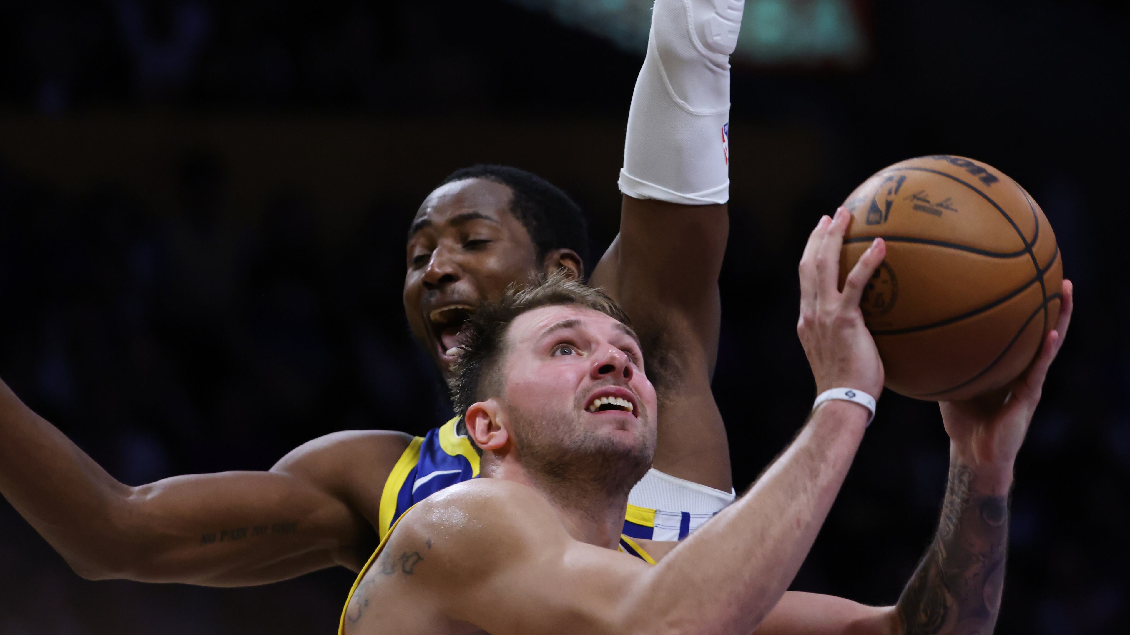 Los Angeles Lakers guard Luka Doncic (77) attempts a shot against the Golden State Warriors during the second half of an NBA basketball game Tuesday, Oct. 21, 2025, in Los Angeles. (AP Photo/Ethan Swope)