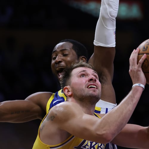 Los Angeles Lakers guard Luka Doncic (77) attempts a shot against the Golden State Warriors during the second half of an NBA basketball game Tuesday, Oct. 21, 2025, in Los Angeles. (AP Photo/Ethan Swope)