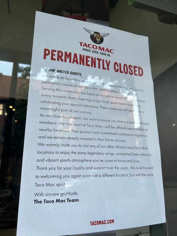 A sign outside Taco Mac's Midtown location Monday confirmed its closing. (Olivia Wakim/AJC)