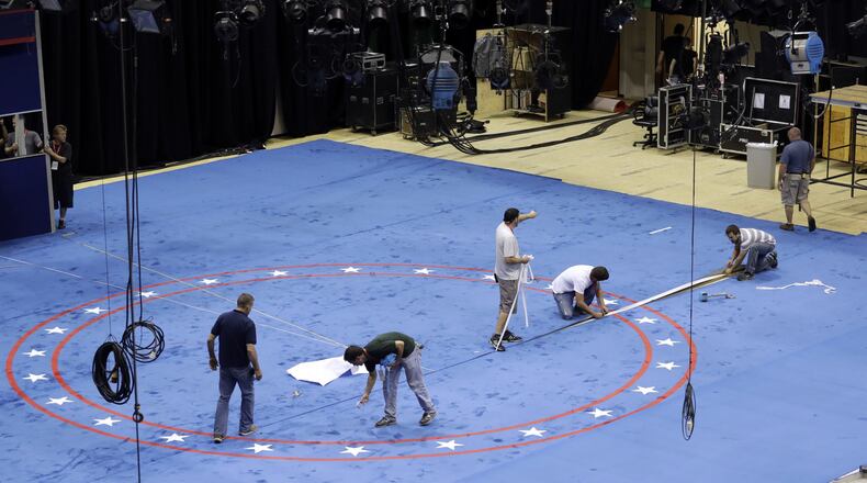 Workers install carpet as preparations continue ahead of the second presidential debate at Washington University in St. Louis, Thursday, Oct. 6, 2016. The town hall debate between Republican presidential candidate Donald Trump and Democratic presidential candidate Hillary Clinton is set for this Sunday. (AP Photo/Jeff Roberson)