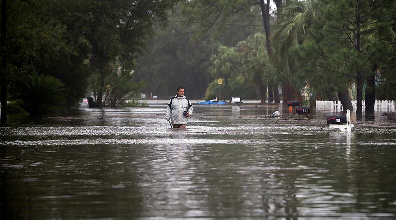 Joey Spalding walks back to his truck down the street where he lives, Monday, Sept. 11, 2017, on Tybee Island, Ga. Spalding just finished repairing his house from nine inches of water after Hurricane Matthew past the island last year. He said the Tropical Storm Irma brought three feet of storm surge into his living room today. (AP Photo/Stephen B. Morton)