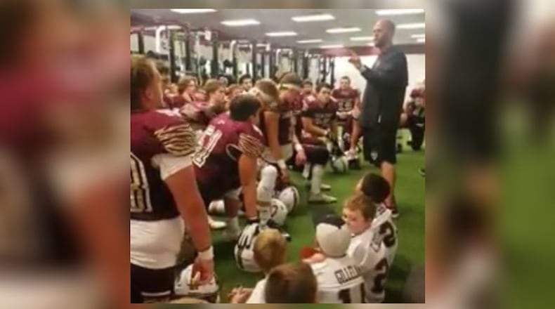 Russell Davis leads the Dawson County High School football team in a pregame prayer.
