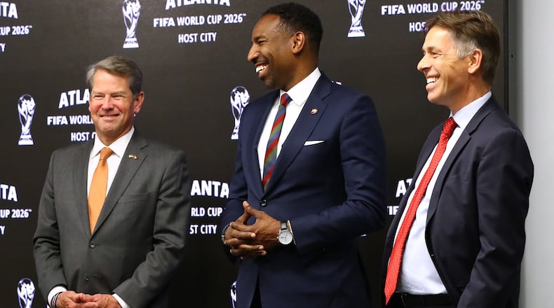 Governor Brian Kemp (from left), Mayor Andre Dickens, and Mercedes-Benz Stadium Chief Operating Officer Dietmar Exler share a laugh reacting during the Host City announcement press conference for the 2026 World Cup at Mercedes-Benz Stadium on Thursday, June 16, 2022, in Atlanta. “Curtis Compton / Curtis.Compton@ajc.com”