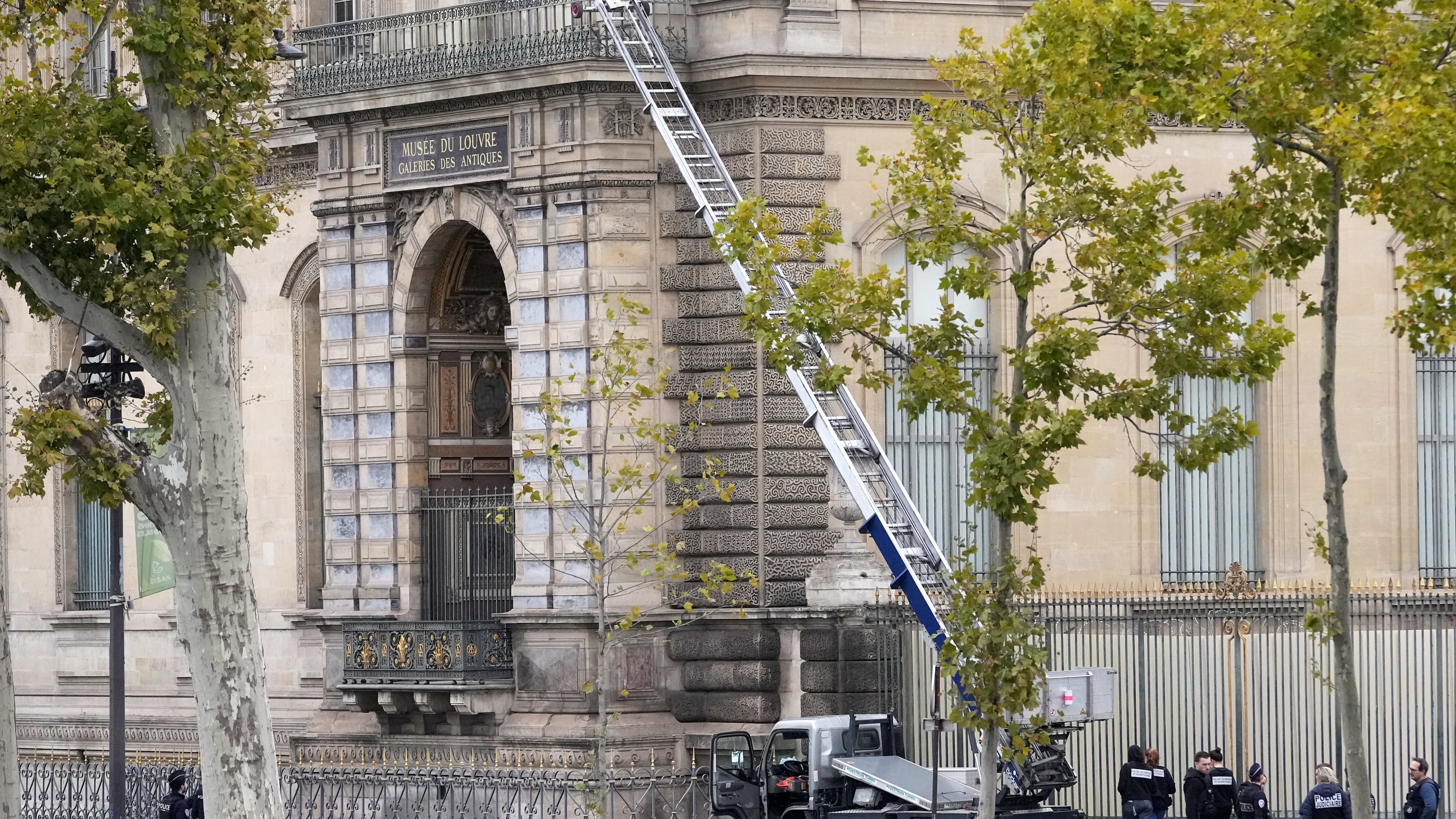 Police officers work by a basket lift used by thieves Sunday, Oct. 19, 2025 at the Louvre museum in Paris. (AP Photo/Thibault Camus)