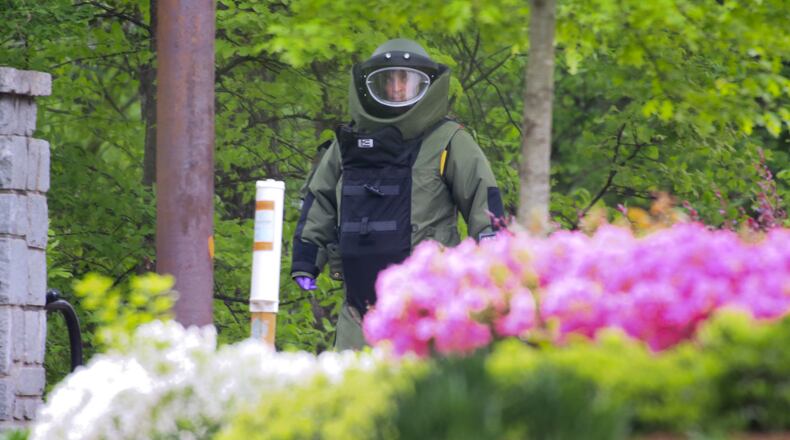 The bomb technician approaches the entrance to the park. The rash of suspicious package reports that have kept the Atlanta police bomb squad scrambling in the wake of Monday's Boston Marathon bombing continued Friday, Apr.19, 2013. JOHN SPINK / JSPINK@AJC.COM