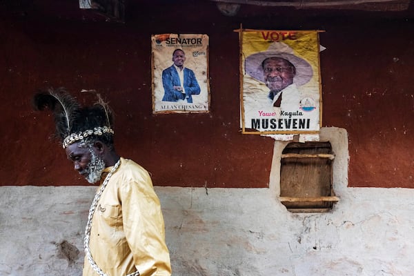 Seer Atukung Tafala, left, walks around his igloo-like shrine in Kampala, Uganda Saturday, June 21, 2025.(AP Photo/Hajarah Nalwadda)