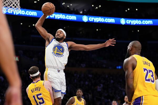 Golden State Warriors guard Moses Moody, center, shoots as Los Angeles Lakers guard Austin Reaves, left, and forward LeBron James defend during the first half of an NBA basketball game Thursday, April 3, 2025, in Los Angeles. (AP Photo/Mark J. Terrill)