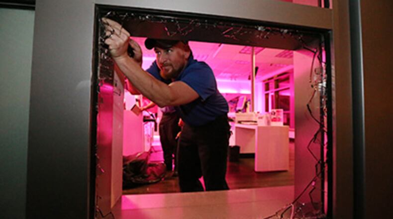 Atlanta police Thursday were investigating a predawn smash-and-grab burglary at the T-Mobile store on 5th Street at Spring Street. JOHN SPINK/jspink@ajc.com
