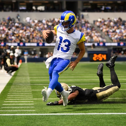 Rams quarterback Stetson Bennett IV (left) runs past Saints linebacker Isaiah Stalbird for a touchdown Saturday, Aug. 22, 2026, in Inglewood, Calif. Bennett was 19-for-31 for 181 yards passing and two rushing TDs. (Kyusung Gong/AP)