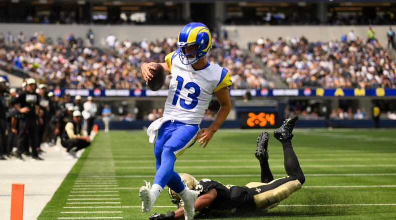 Rams quarterback Stetson Bennett IV (left) runs past Saints linebacker Isaiah Stalbird for a touchdown Saturday, Aug. 22, 2026, in Inglewood, Calif. Bennett was 19-for-31 for 181 yards passing and two rushing TDs. (Kyusung Gong/AP)