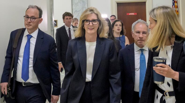 Goldman Sachs senior counsel Kathryn Ruemmler, center, arrives for a House Committee on Oversight and Government Reform hearing regarding her ties to Jeffrey Epstein, on Capitol Hill, Wednesday, July 15, 2026, in Washington. (AP Photo/Rod Lamkey, Jr.)
