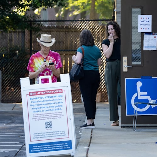 Voters stand outside the Joan P. Garner library voting precinct before voting in the Georgia Public Service Commission runoff election. Tuesday, July 15, 2025 (Ben Hendren for the AJC)