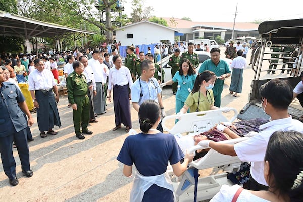 In this image provided by The Myanmar Military True News Information Team, Myanmar's military leader Senior Gen. Min Aung Hlaing, center, inspects victims caused by an earthquake Friday, March 28, 2025, in Naypyitaw, Myanmar. (The Myanmar Military True News Information Team via AP)