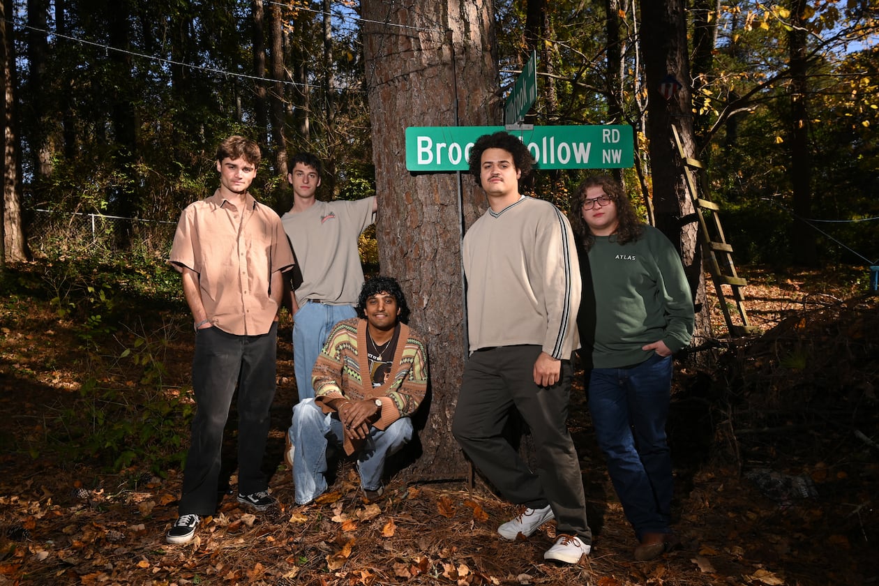 Penelope Road members James Kopp (from left), Charles Eastman, Koan Roy-Meighoo, Anthony Smith and Max Moore hang at Eastman’s home on Thursday, Nov. 13, 2025, in Brookhaven. They’ll perform three headlining shows at venues across Atlanta this month. (Hyosub Shin/AJC)
