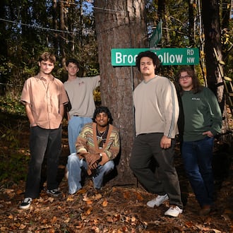 Penelope Road members James Kopp (from left), Charles Eastman, Koan Roy-Meighoo, Anthony Smith and Max Moore hang at Eastman’s home on Thursday, Nov. 13, 2025, in Brookhaven. They’ll perform three headlining shows at venues across Atlanta this month. (Hyosub Shin/AJC)
