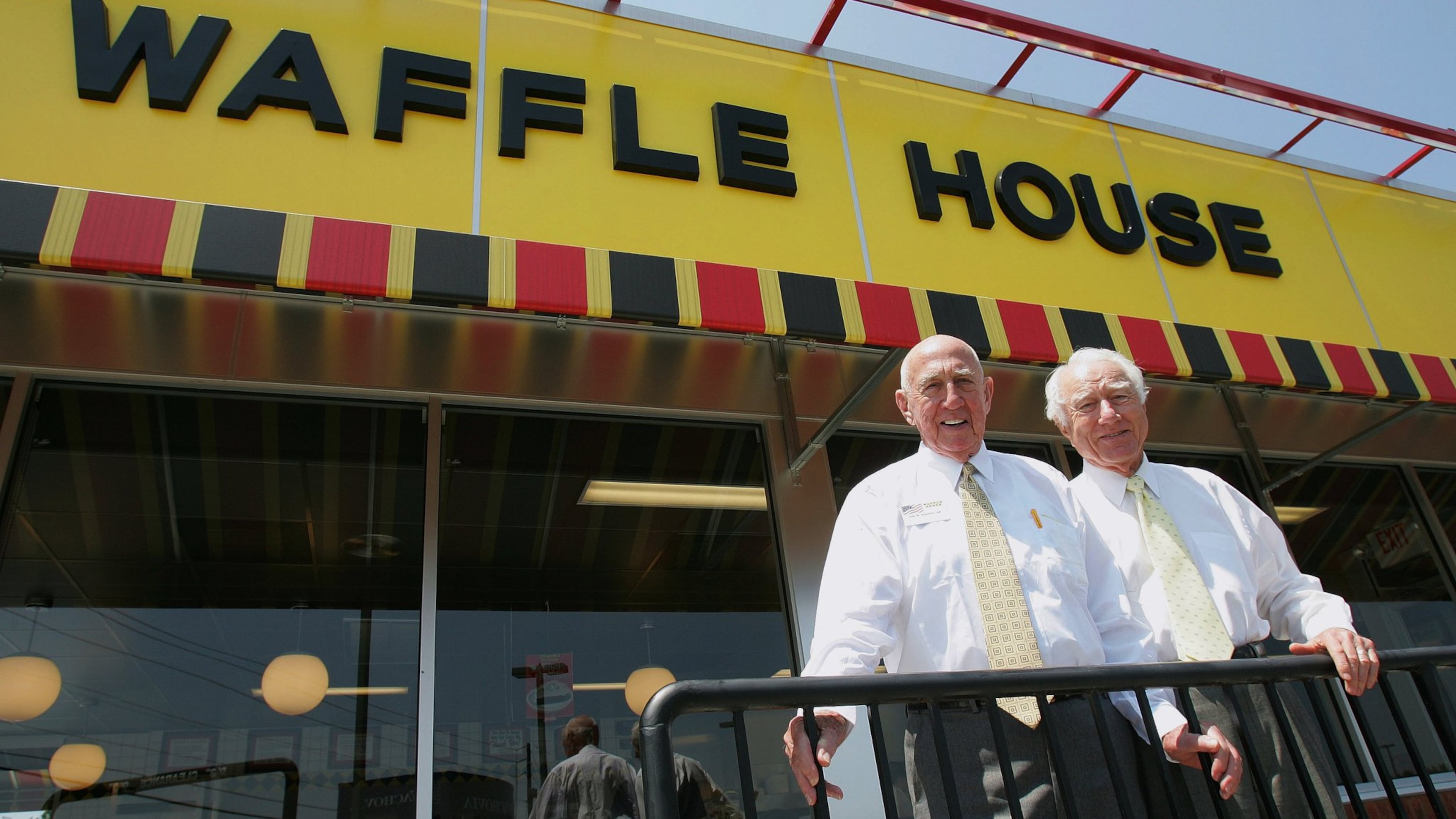 In this 2005 photo, Waffle House founders Joe Rogers Sr., left, and Tom Forkner pose in front of a restaurant in Norcross. The Southern diner chain began 70 years ago this month. (Ric Feld/AP)