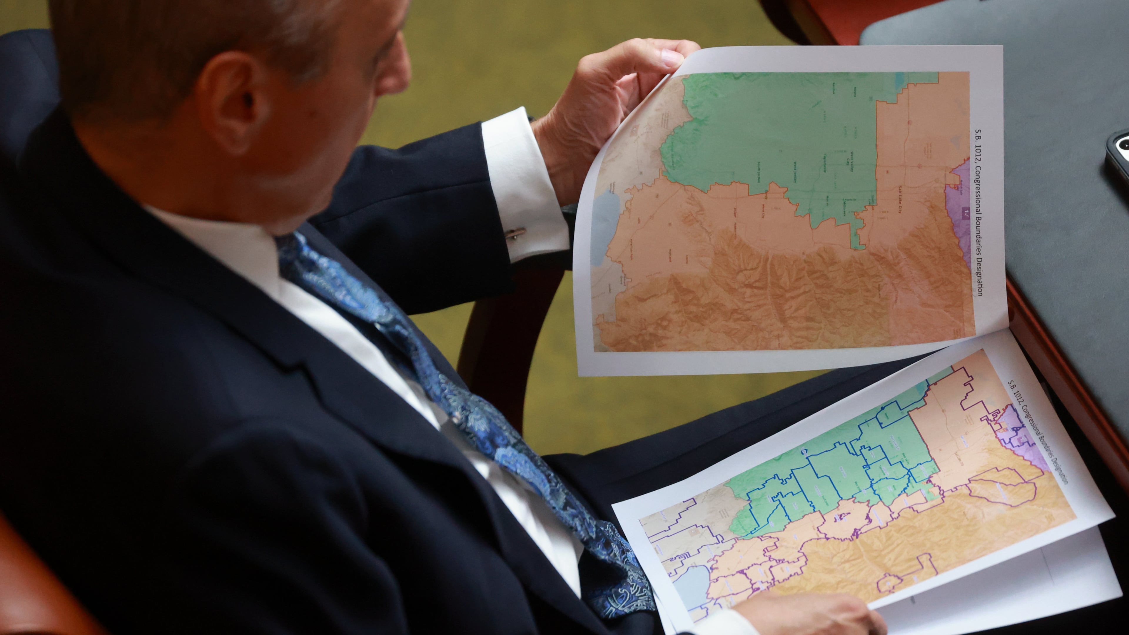 FILE -Rep. Cory Maloy, R-Lehi, holds a packet of potential redistricting maps as SB1012 Congressional Boundaries Designation is discussed in the House chamber during a special session at the Capitol on Monday, Oct. 6, 2025, in Salt Lake City. (Kristin Murphy/The Deseret News via AP, File)