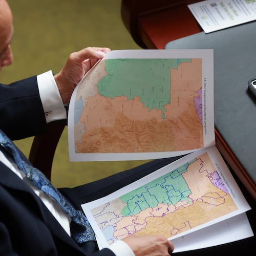 FILE -Rep. Cory Maloy, R-Lehi, holds a packet of potential redistricting maps as SB1012 Congressional Boundaries Designation is discussed in the House chamber during a special session at the Capitol on Monday, Oct. 6, 2025, in Salt Lake City. (Kristin Murphy/The Deseret News via AP, File)