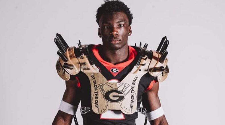 Lovasea Carroll, here posing for pictures on his Georgia visit, was recruited to UGA to play running back. But circumstances on defense have him playing cornerback for the Bulldogs this spring. (UGA photo)