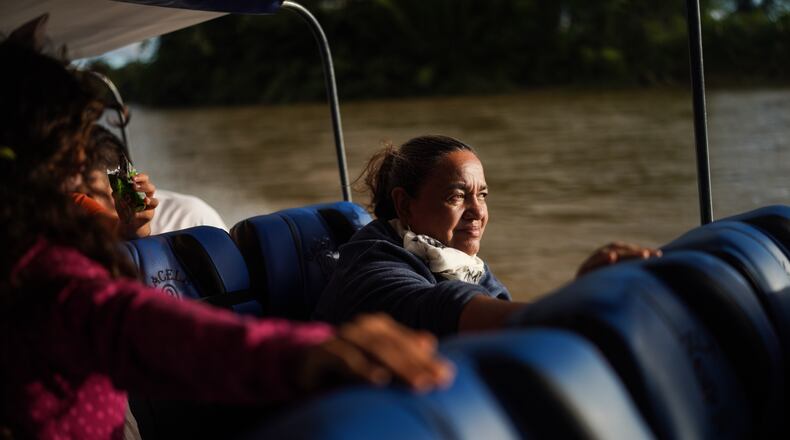 Jani Silva, 63, sails in a boat on the Putumayo River, on the outskirts of Puerto Asis, Colombia, Wednesday, Nov. 26, 2025. (AP Photo/Ivan Valencia)