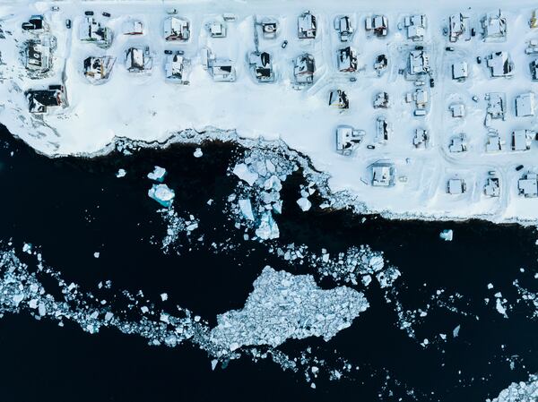 Houses covered by snow are seen on the coast of a sea inlet of Nuuk, Greenland, Friday, March 7, 2025. (AP Photo/Evgeniy Maloletka)