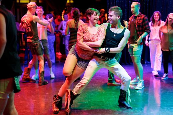 A smiling pair hit the floor at DanceOut Atlanta's Dolly Parton-themed line dancing event. (Frankie Cole for the AJC)