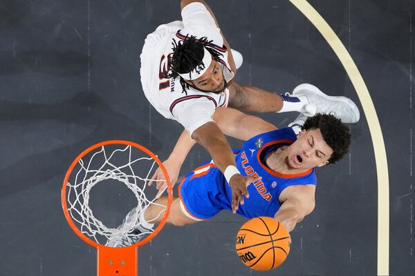 Florida's Walter Clayton Jr., right, shoots as Auburn's Chaney Johnson (31) defends during the second half in the national semifinals at the Final Four of the NCAA college basketball tournament, Saturday, April 5, 2025, in San Antonio. (AP Photo/Eric Gay)