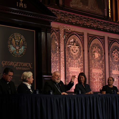 FILE - The archbishop of Miami, Thomas Wenski, raises his hand while addressing a crowd during a panel on immigration at Georgetown University in Washington, Thursday, Sept. 11, 2025. (AP Photo/Luis Andres Henao,File)