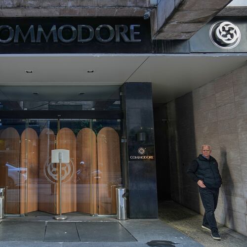 A man stands in the closed main entrance of the Commodore hotel, in Beirut, Lebanon, Sunday, Jan. 11, 2026. (AP Photo/Hussein Malla)