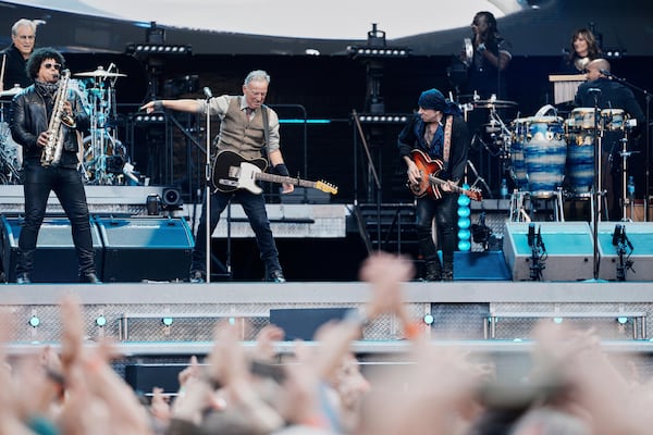 Bruce Springsteen, center, performs with the E Street Band at the Olympic Stadium in Berlin, Germany, Wednesday, June 11, 2025. (AP Photo/Markus Schreiber)