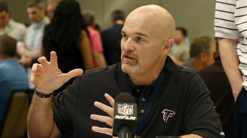 Falcons coach Dan Quinn talks with a reporter during the NFC head-coaches breakfast at the NFL annual meetings Wednesday, March 29, 2017, in Phoenix. (AP Photo/Ross D. Franklin)