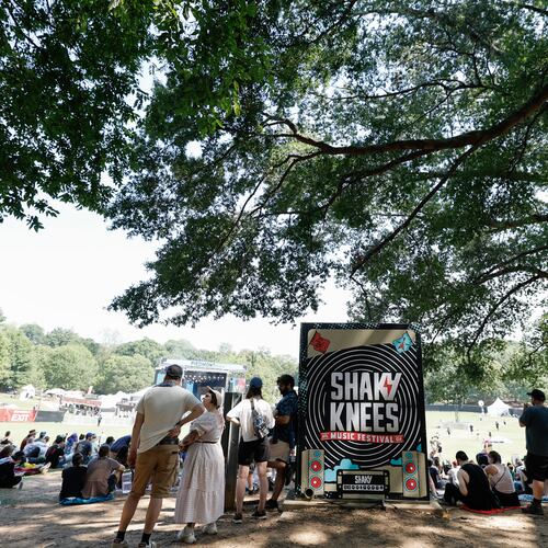 People congregate in the shade under a large tree during the Shaky Knees music festival at Piedmont Park, Saturday, Sept. 19, 2026, in Atlanta. (Erik S. Lesser for the AJC)
