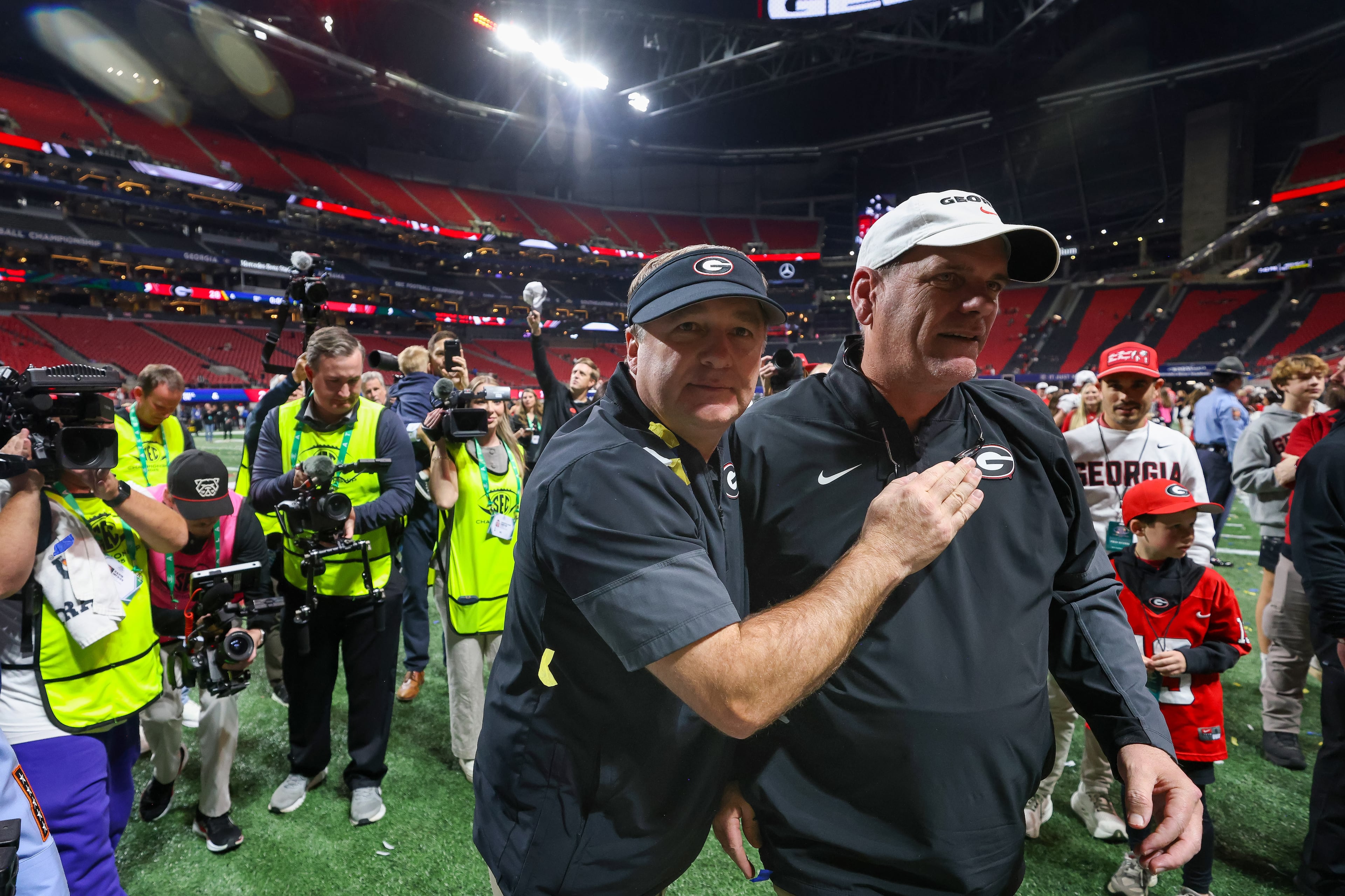Georgia head coach Kirby Smart celebrates with offensive coordinator Mike Bobo after a 28-7 victory over Alabama in the SEC Championship game at Mercedes-Benz Stadium, Saturday, Dec. 6, 2025, in Atlanta. (Jason Getz / AJC)