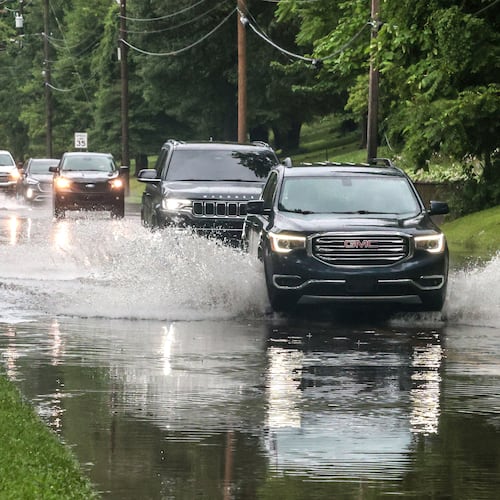 Drivers maneuver their vehicles through high water flooding West Parrish Avenue after a heavy rainfall, Saturday, June 27, 2026, in Owensboro, Ky. (Greg Eans/The Messenger-Inquirer via AP)