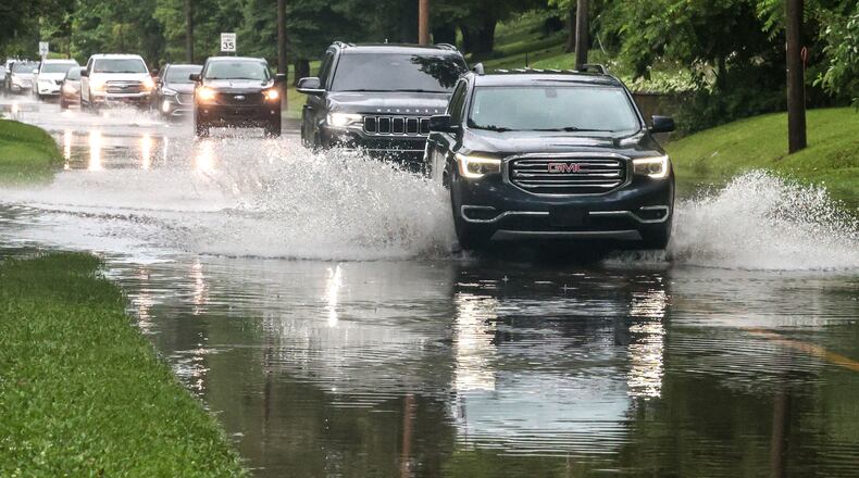 Drivers maneuver their vehicles through high water flooding West Parrish Avenue after a heavy rainfall, Saturday, June 27, 2026, in Owensboro, Ky. (Greg Eans/The Messenger-Inquirer via AP)