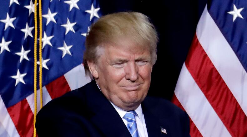 Republican presidential candidate Donald Trump points to the audience after delivering an immigration policy speech during a campaign rally at the Phoenix Convention Center, Wednesday, Aug. 31, 2016, in Phoenix. (AP Photo/Matt York)