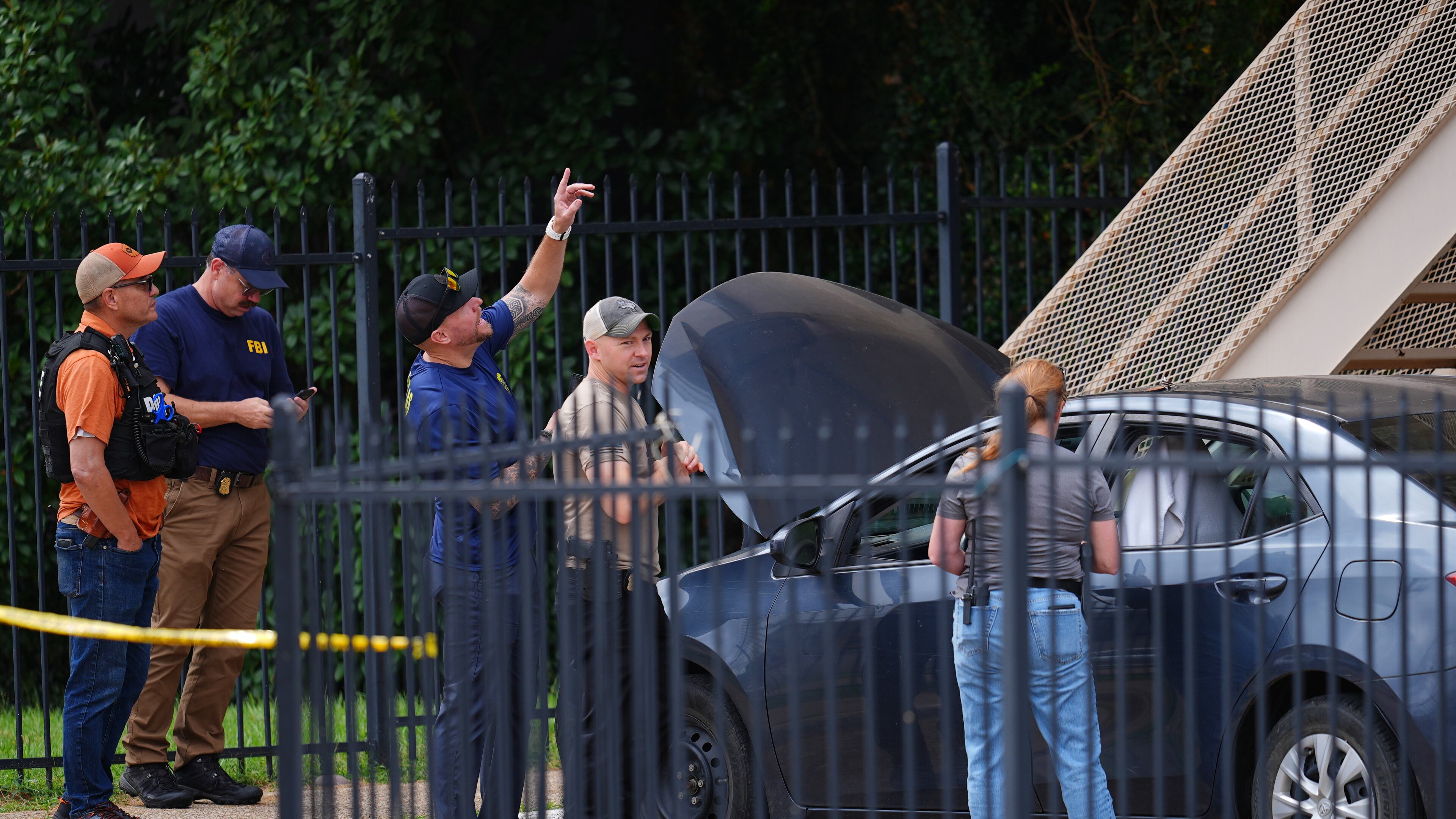 A law enforcement agents search a vehicle near the scene of a shooting at a U.S. Immigration and Customs Enforcement office in Dallas on Wednesday, Sept. 24, 2025. (AP Photo/Julio Cortez)