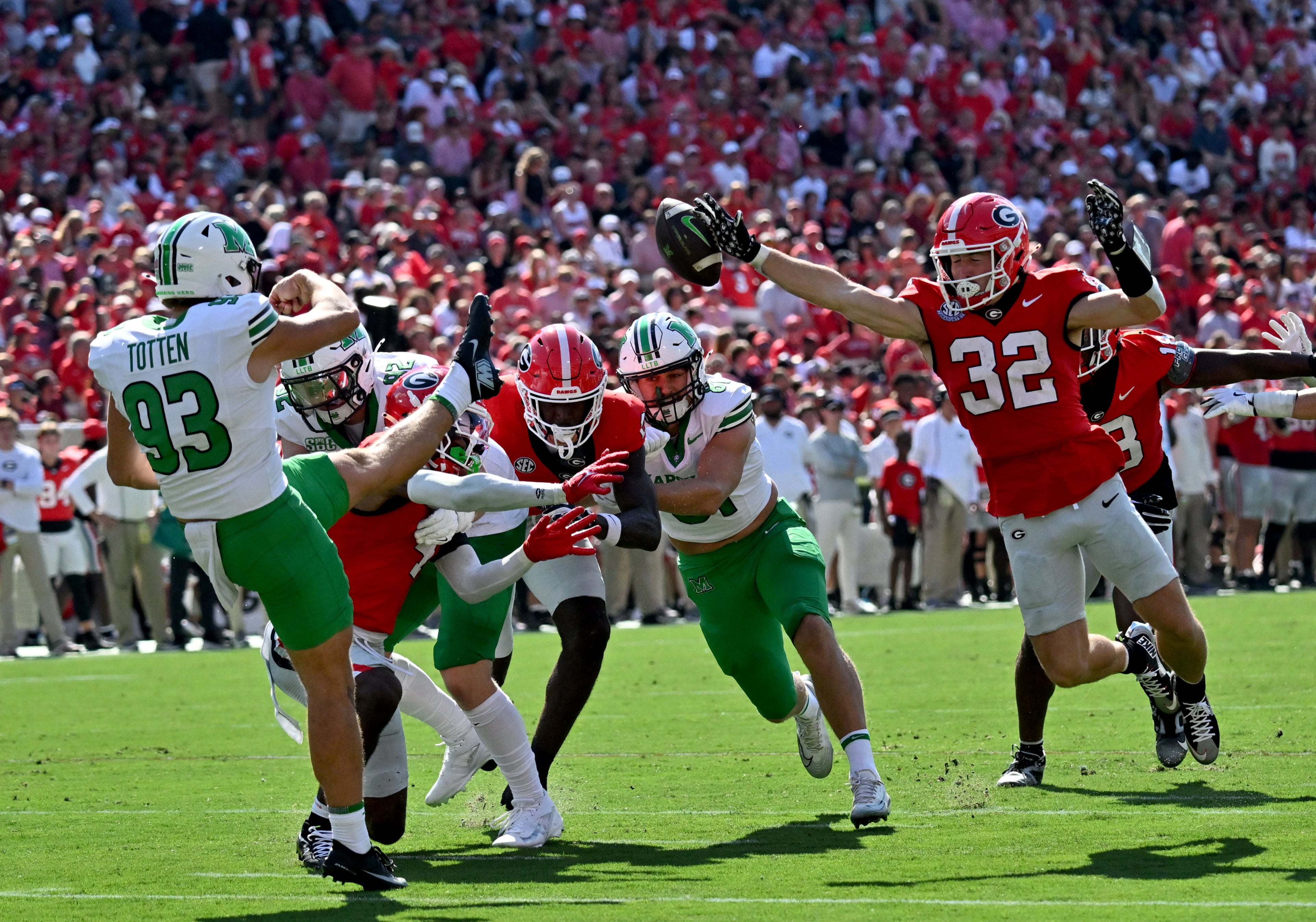Georgia running back Cash Jones (32) blocks the kick by Marshall place kicker Nathan Totten (93) during the first half in an NCAA football game at Sanford Stadium, Saturday, August 30, 2025, in Athens. (Hyosub Shin / AJC)