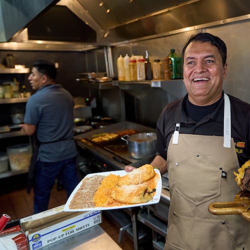 Mexican restaurant owner-chef Marco Mendoza prepares a hot molcajete, a traditional Mexican dish, at Cuernavaca's Grill in downtown Los Angeles, Tuesday, April 28, 2026. (AP Photo/Damian Dovarganes)