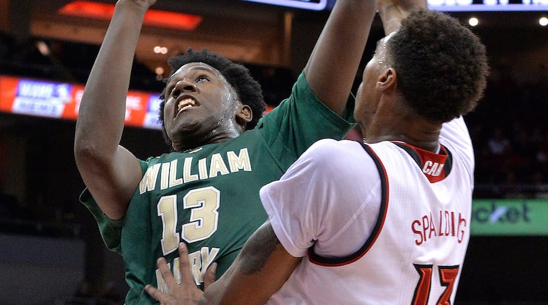 William & Mary's Nathan Knight (13) drives to the basket against Louisville forward Ray Spalding (13) during the first half Monday, Nov. 14, 2016 in Louisville Ky. (Timothy D. Easley/AP)