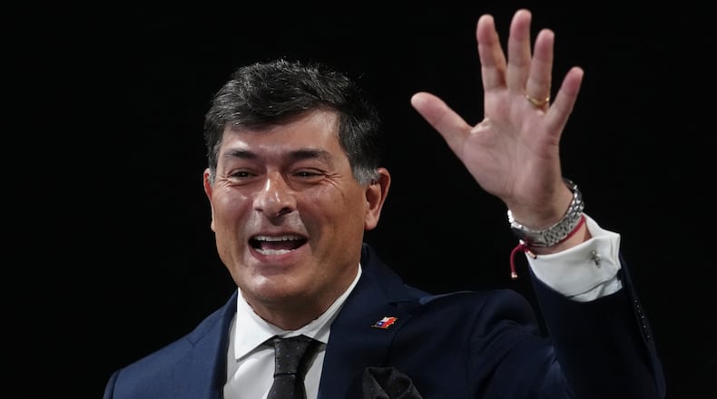 FILE - Chilean presidential candidate Franco Parisi waves upon arriving to take part in a presidential debate, in Santiago, Chile, Sept. 10, 2025. (AP Photo/Esteban Felix)