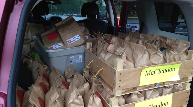 Snax Sax from Embry Hills United Methodist Church are headed to McClendon Elementary School. The wooden crates that hold the snacks were made by Max Ware, an Eagle Scout who attends Embry Hills. McClendon Elementary School is the largest recipient of sacks from the program. The church prepares sacks for about 360 children each week. CONTRIBUTED BY JUDY CAMPBELL