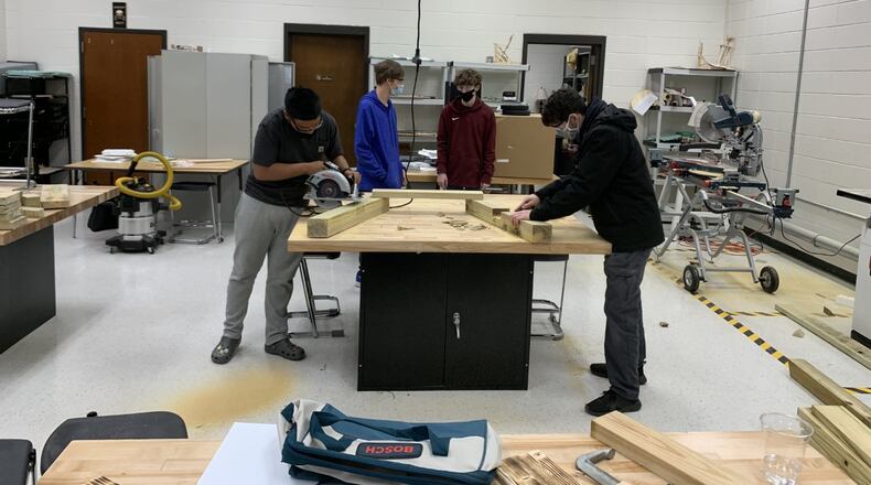 Brookwood High School students Edward Moreno, Jacob Ogelvie, Bailey Busby and Simon Bratescu build picnic tables at school. (Courtesy photo)