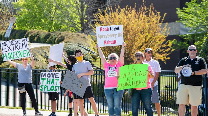 Students, teachers and community members demonstrate in front of Sprayberry High School during on Sunday, April 18, 2021, in Marietta, Georgia. Parents and community members held the rally to encourage Cobb County school board members to allocate funds to renovate the school. CHRISTINA MATACOTTA FOR THE ATLANTA JOURNAL-CONSTITUTION