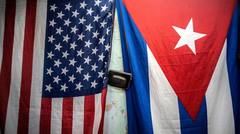 FILE - A U.S. and Cuban flag hangs on a wall in Havana, Cuba, Monday, Jan 11, 2021. (AP Photo/Ramon Espinosa, File)