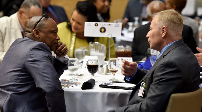 Clayton County Police Chief Michael Register, right, and Clayton County Sheriff Victor Hill talk at Clayton County’s Annual State of the County Address last March. BRANT SANDERLIN/BSANDERLIN@AJC.COM