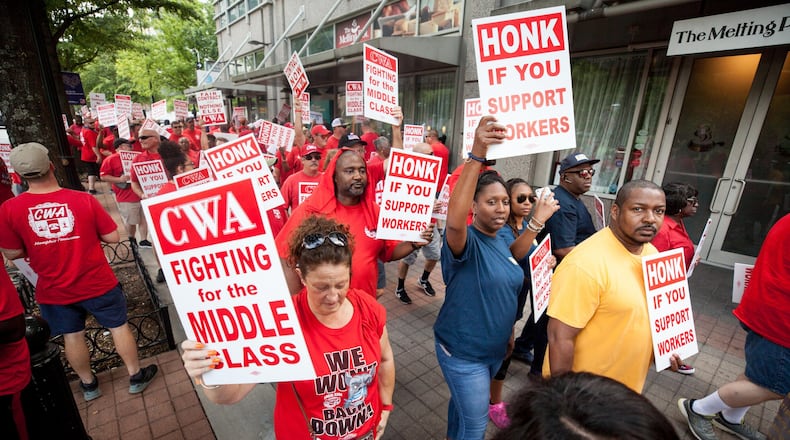 Workers walk along Peachtree Street during a CWA rally outside of AT&T’s offices on Saturday, Aug. 3, 2019, in Atlanta. (Photo: BRANDEN CAMP/SPECIAL TO THE AJC)
